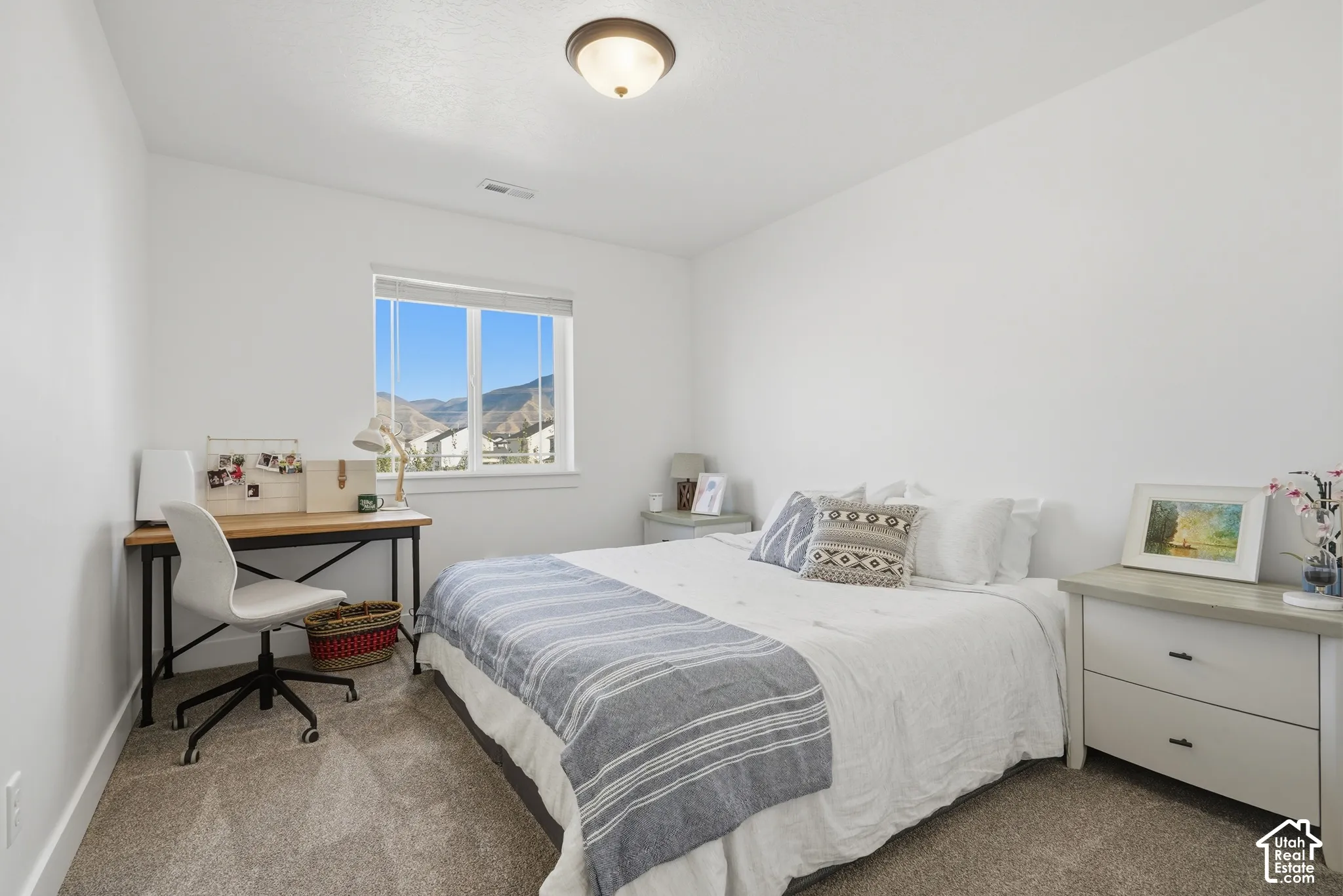 Carpeted room with a ceiling-mounted light fixture, a window, and white walls