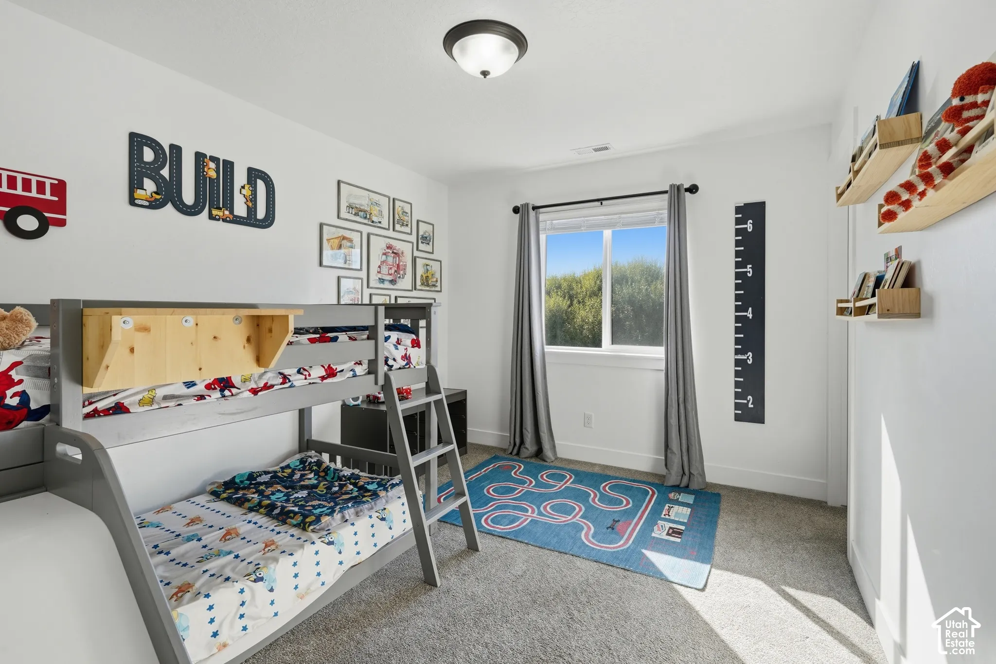 Recessed window with exterior scenery, overhead flush mount light fixture, and plush carpeting