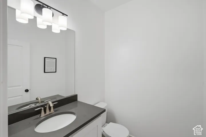 Vanity with a solid surface countertop, undermount sink, and brushed nickel faucet