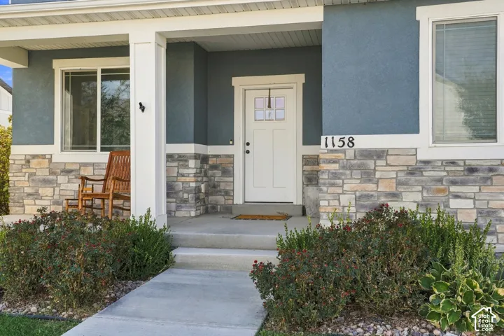 Covered front porch with stone and stucco exterior