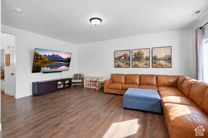 Wood-finish flooring, recessed ceiling lighting, and a window with roller shades