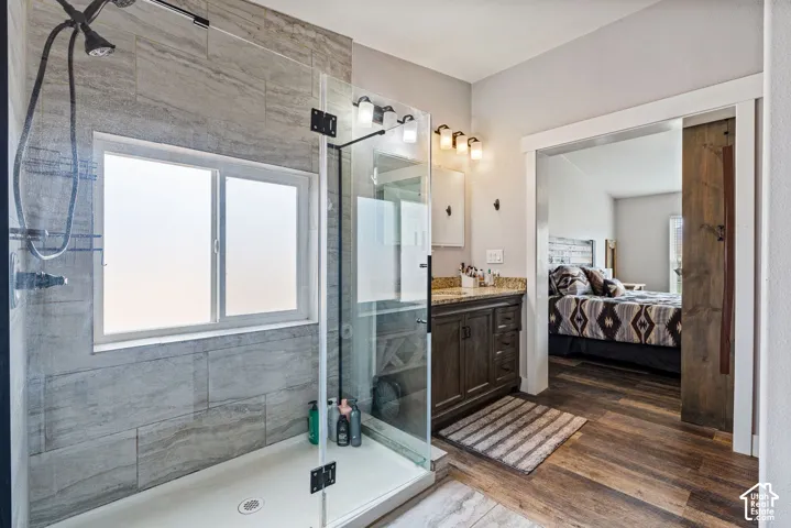 Glass-enclosed shower with gray tile surround and frosted window