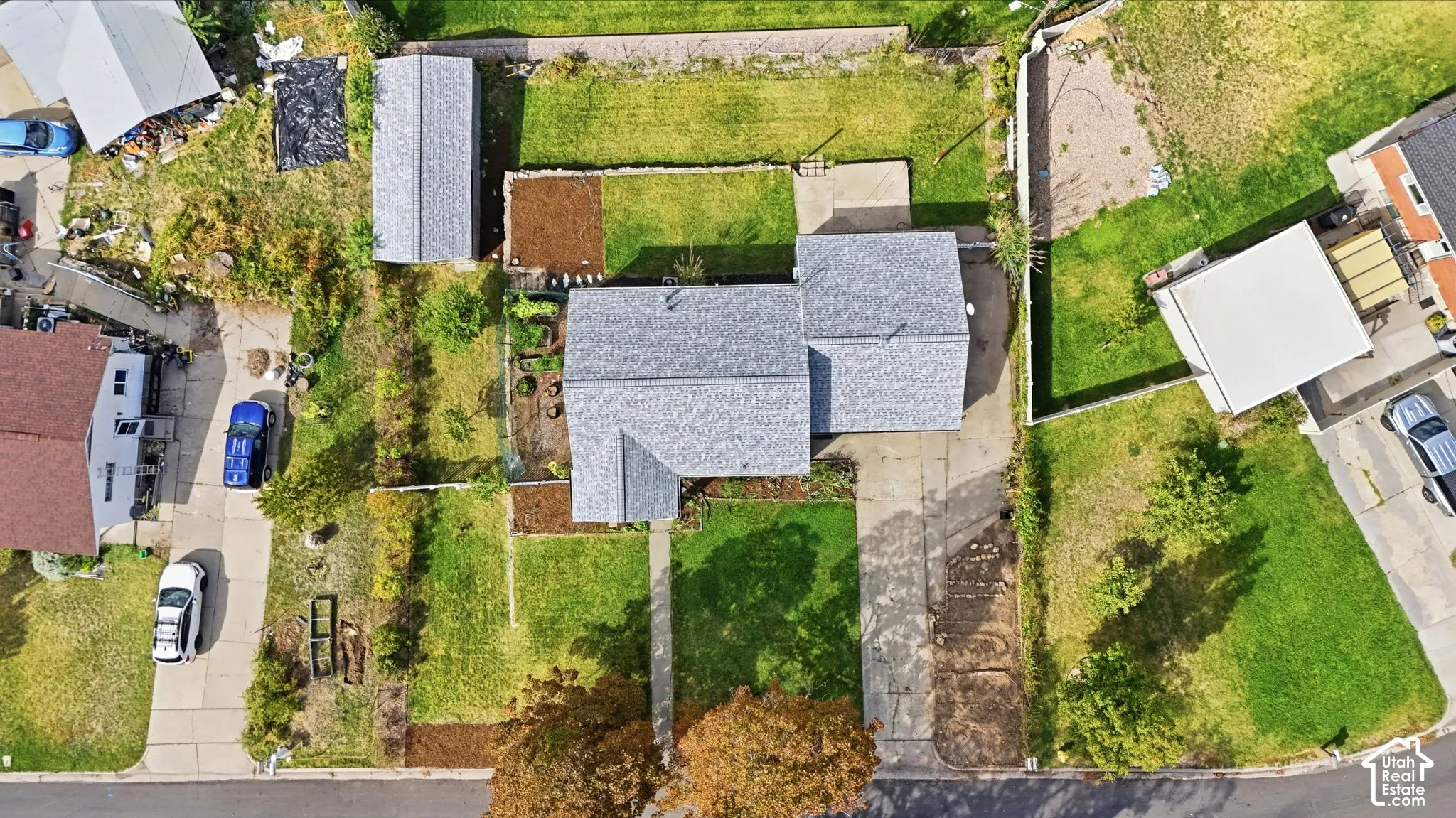 Main residence with a grey shingle roof, accompanied by an accessory structure featuring a matching shingle roof