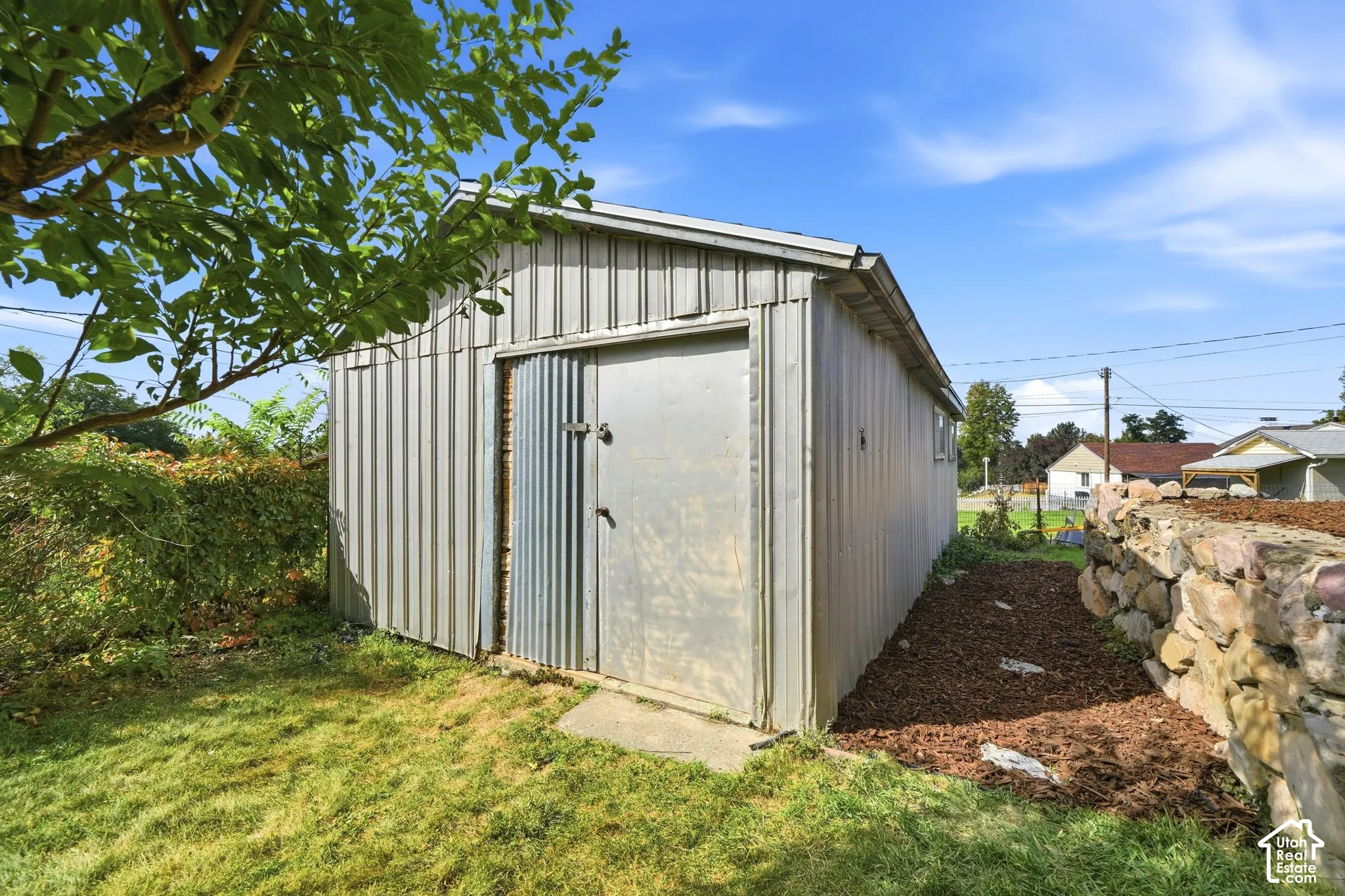 Corrugated metal storage shed with a gabled roof