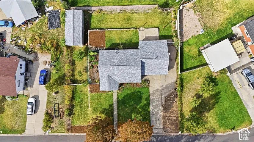 Main residence with a grey shingle roof, accompanied by an accessory structure featuring a matching shingle roof