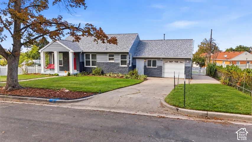 Front exterior with a covered porch, attached garage, and a concrete driveway
