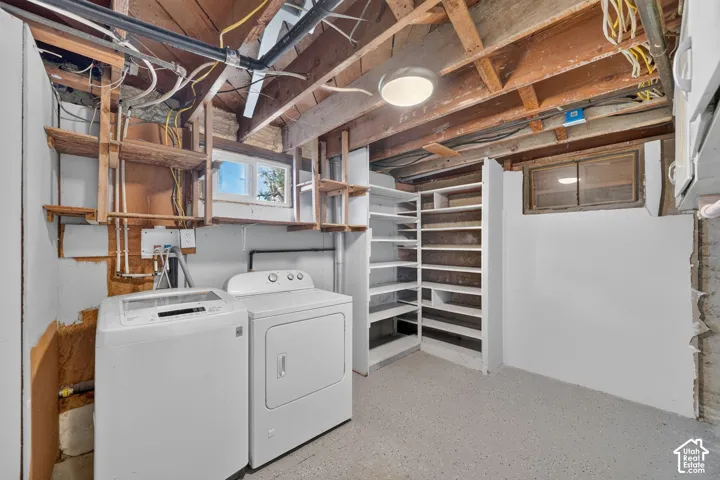 Built-in shelving, painted concrete flooring, recessed window, and exposed ceiling joists