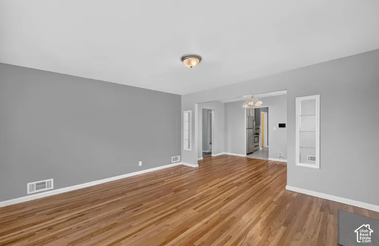 Wood-finish flooring throughout, with neutral gray wall paint