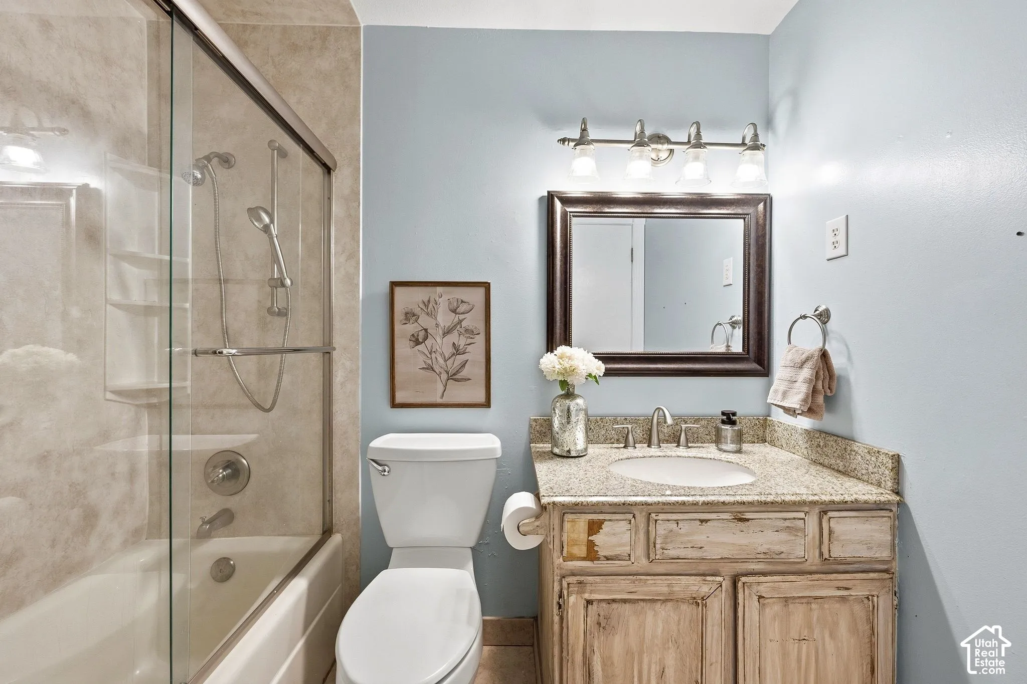 Built-in bathtub with glass sliding enclosure and showerhead with handheld sprayer