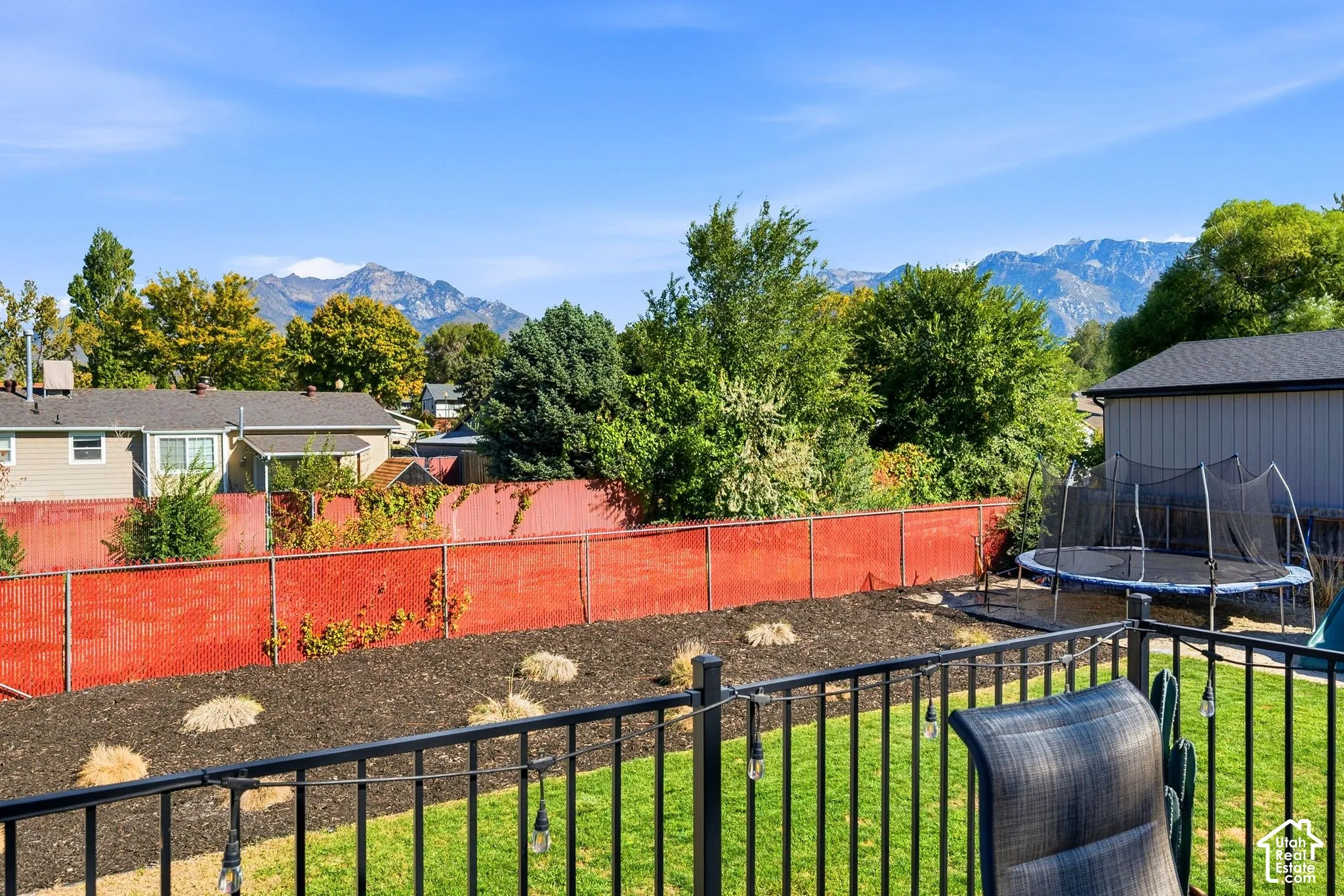 Manicured lawn with a privacy fence and garden beds