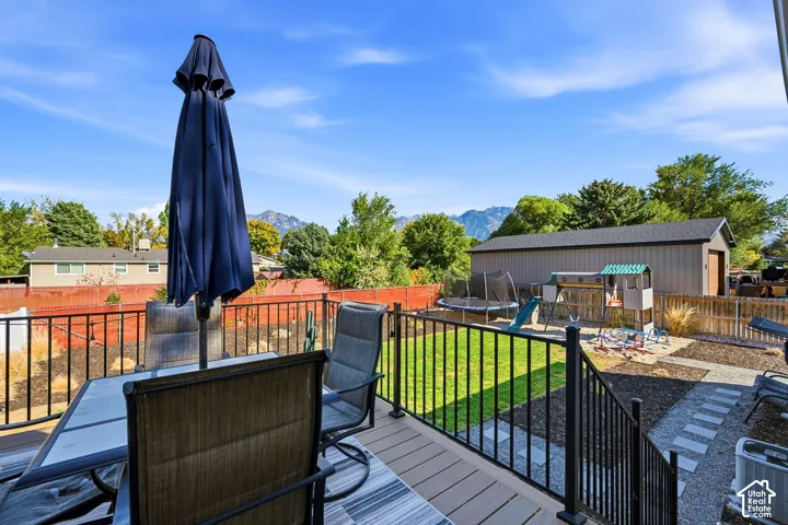 Spacious deck with composite decking, black metal railings, and a manicured lawn