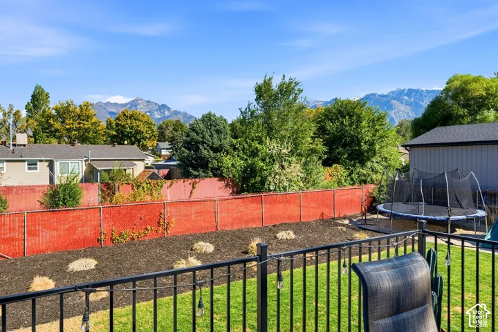 Manicured lawn with a privacy fence and garden beds