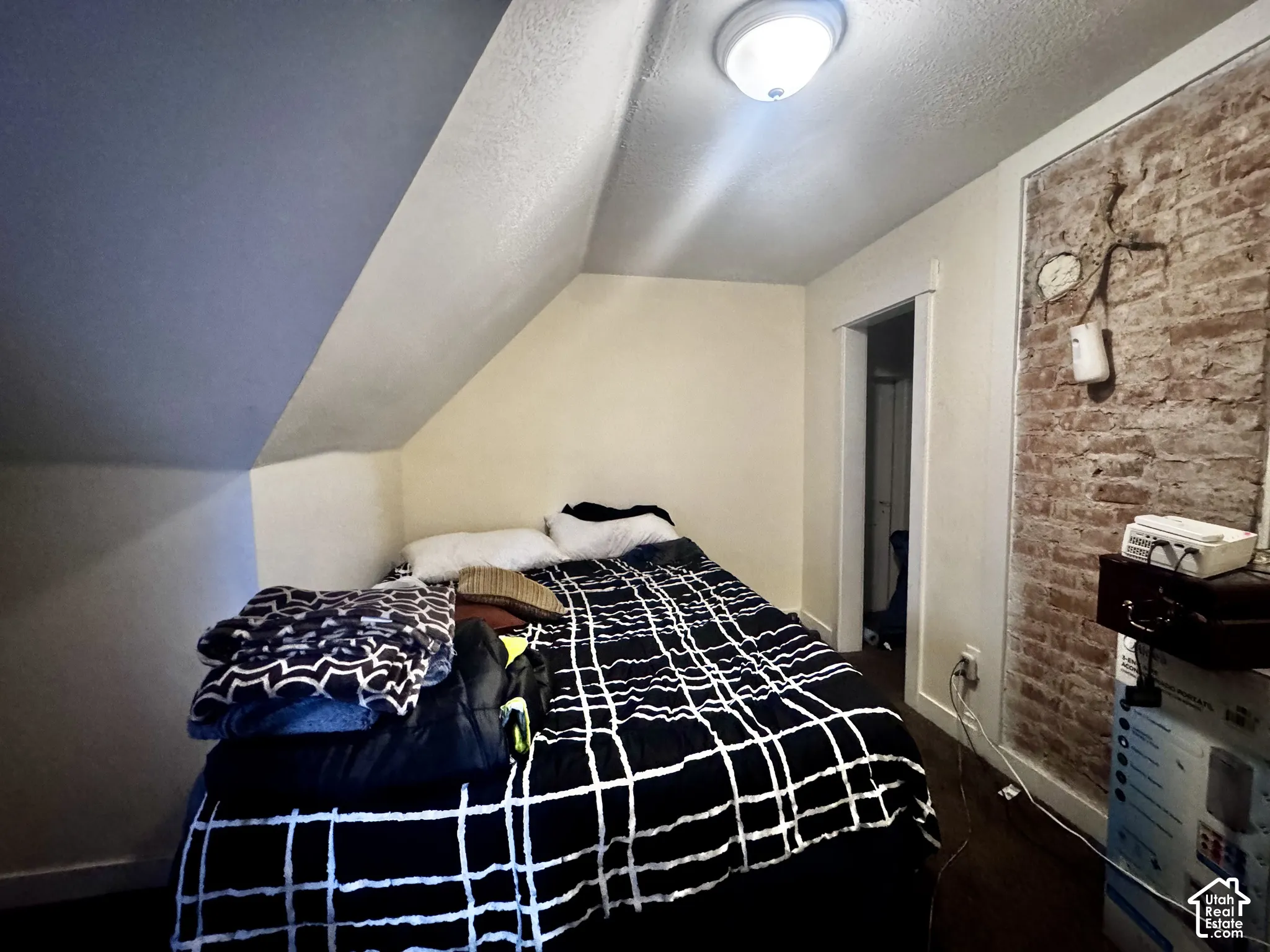 Exposed brick wall detail and sloped ceiling