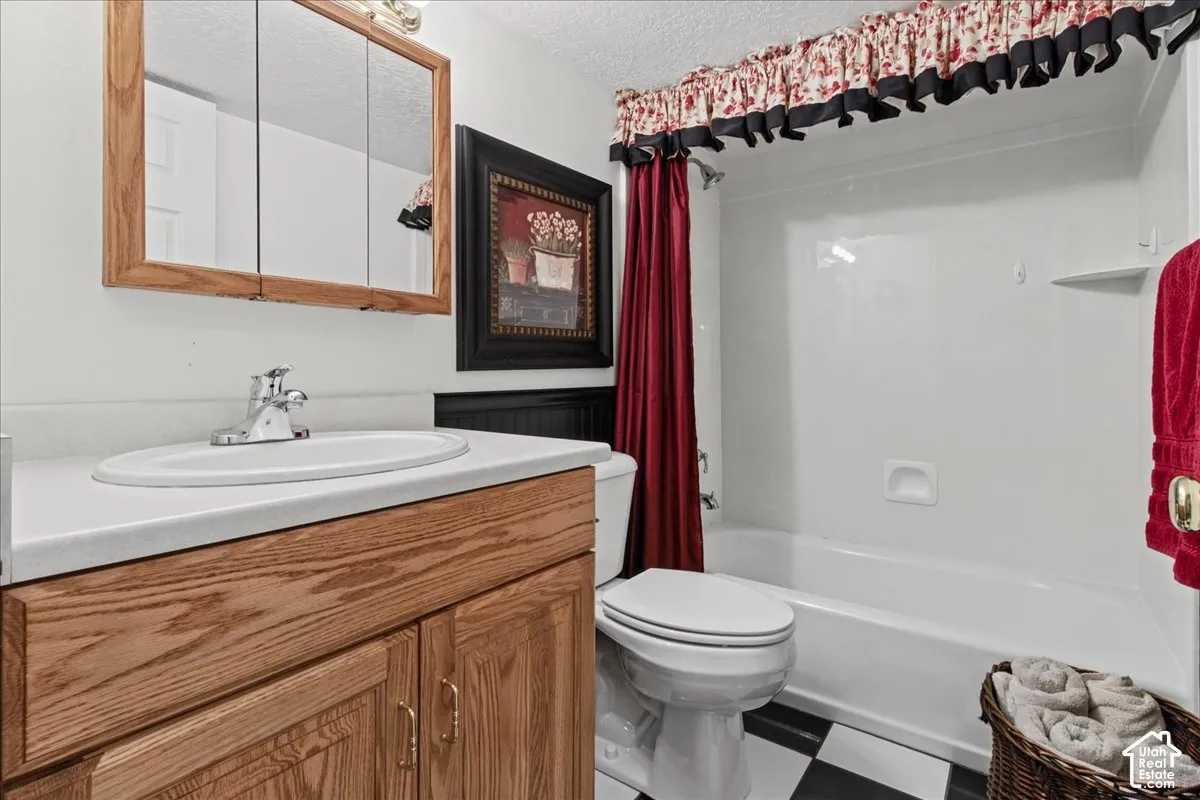 Vanity with an integrated sink, polished chrome faucet, and wood-finish cabinetry
