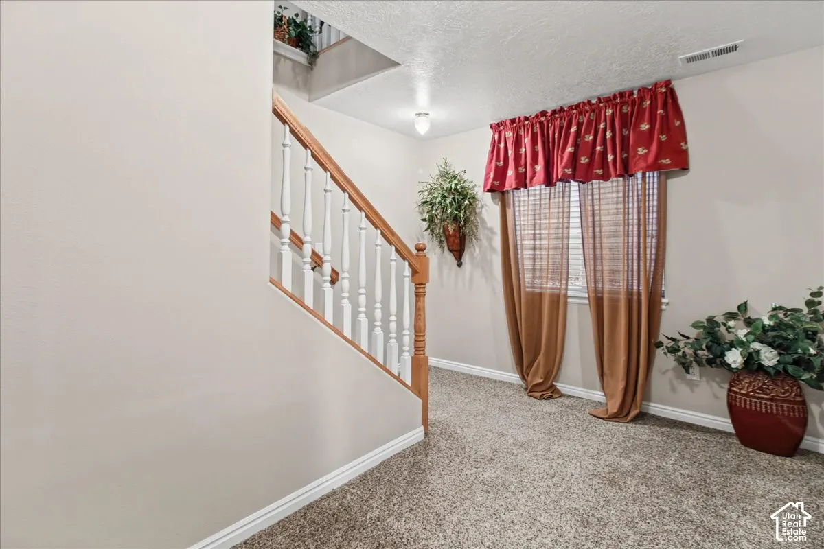 Staircase with wood-finish handrail and white balusters