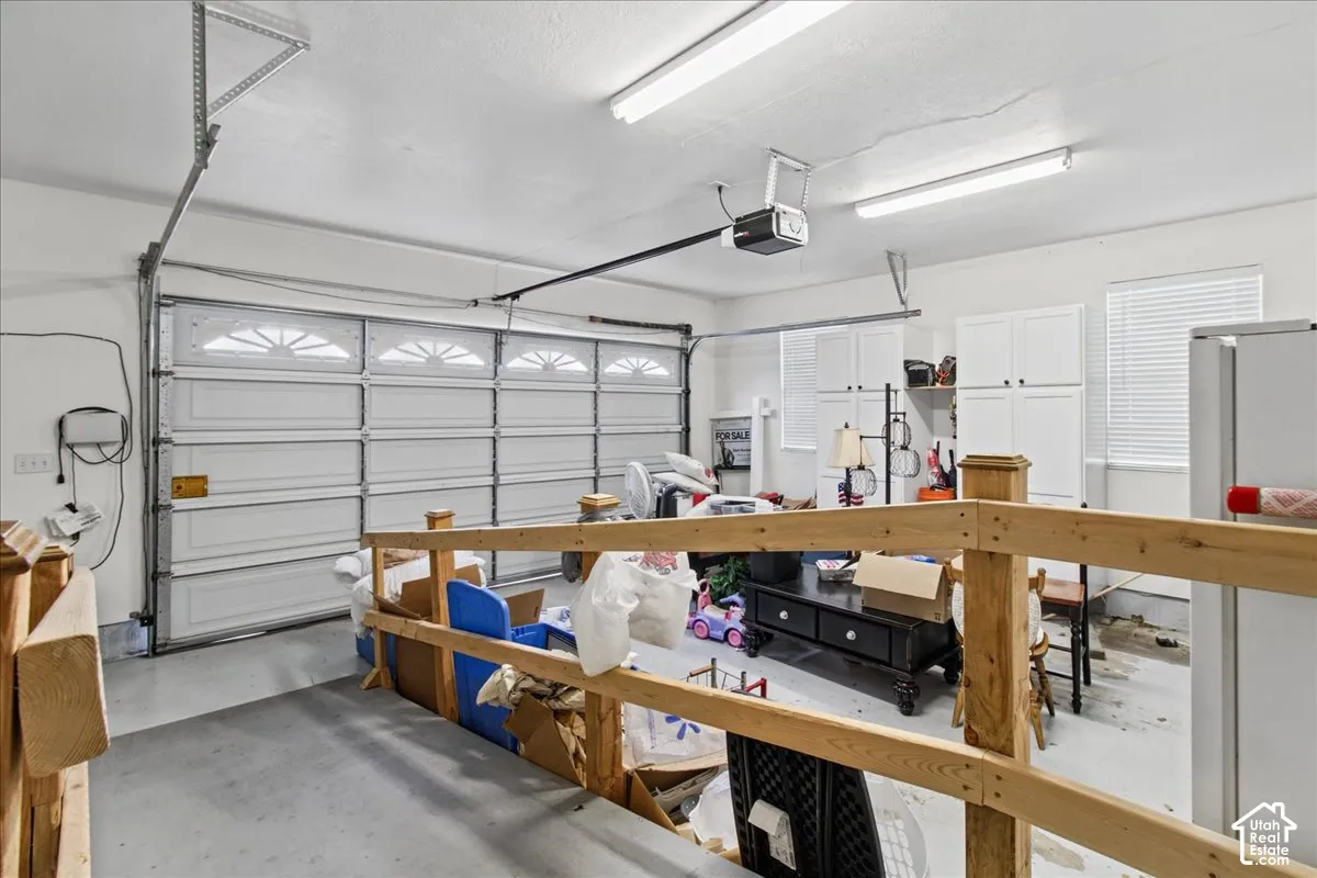 Garage with automatic door opener and overhead fluorescent lighting