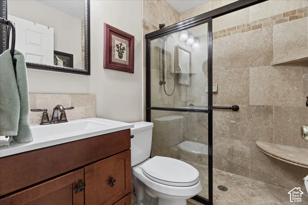Wood-finish vanity with an integrated sink and bronze-finish faucet