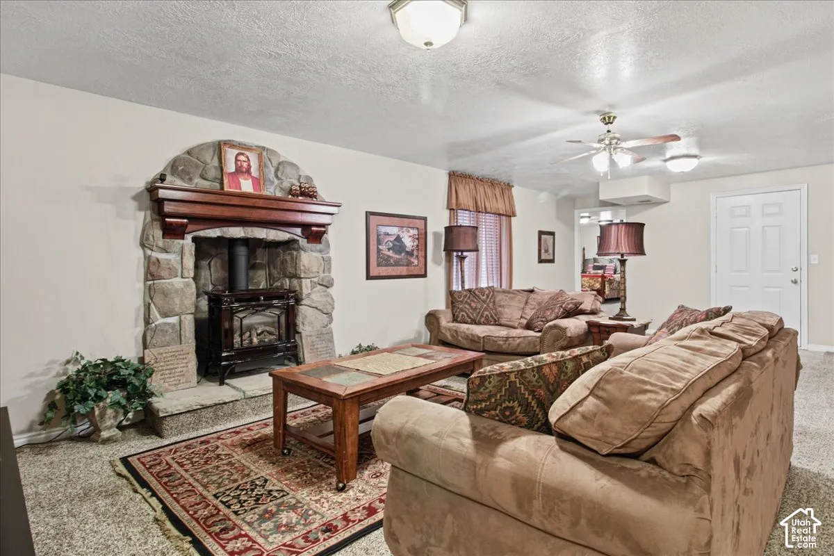 Stone-clad fireplace with wood-burning stove and mantelpiece