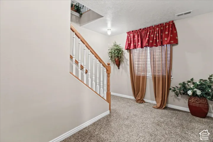 Staircase with wood-finish handrail and white balusters
