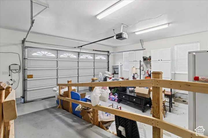 Garage with automatic door opener and overhead fluorescent lighting