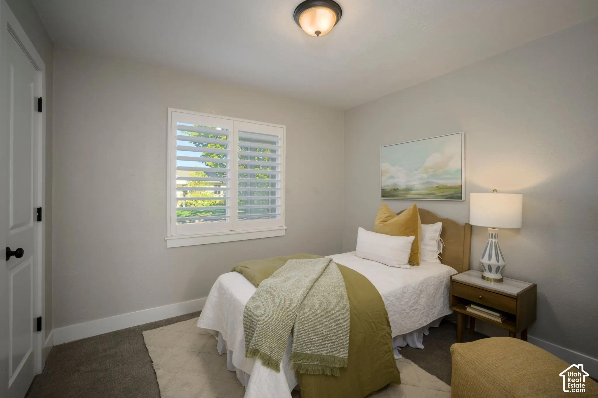 Recessed window with white plantation shutters, carpeted flooring, and a flush-mount ceiling light
