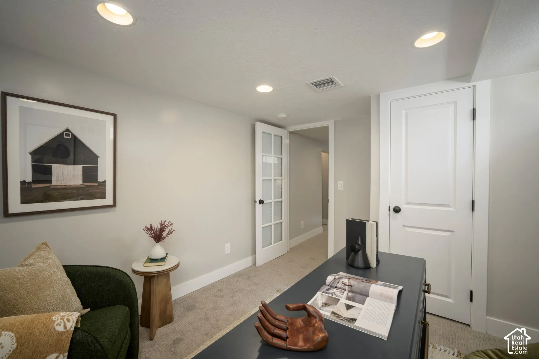 Recessed ceiling lighting, light gray wall paint, white trim, paneled interior door, and French panel door
