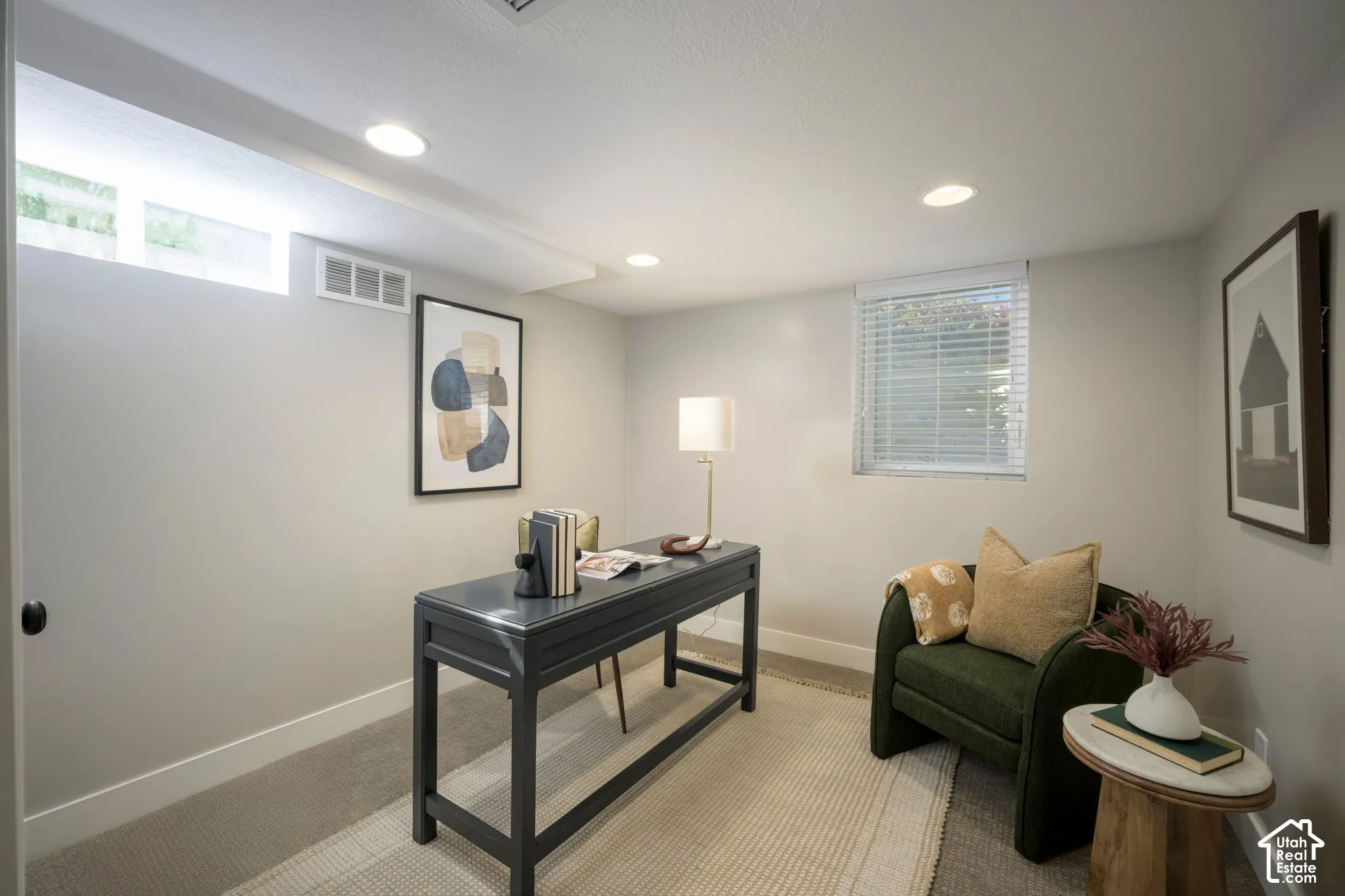 Recessed lighting, wall-to-wall carpeting, and neutral wall tones