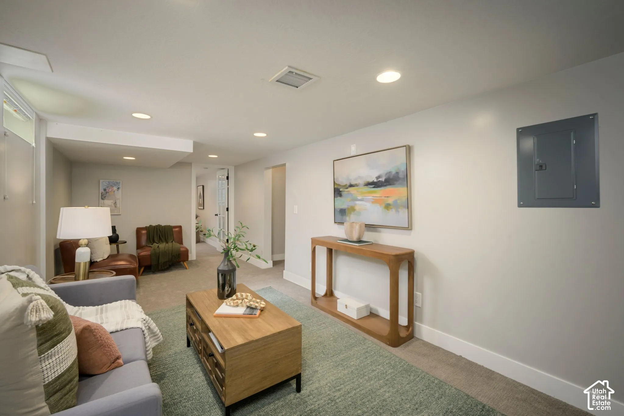 Downstairs Family Room featuring recessed lighting illuminates the living space with light gray walls and light-colored carpeting