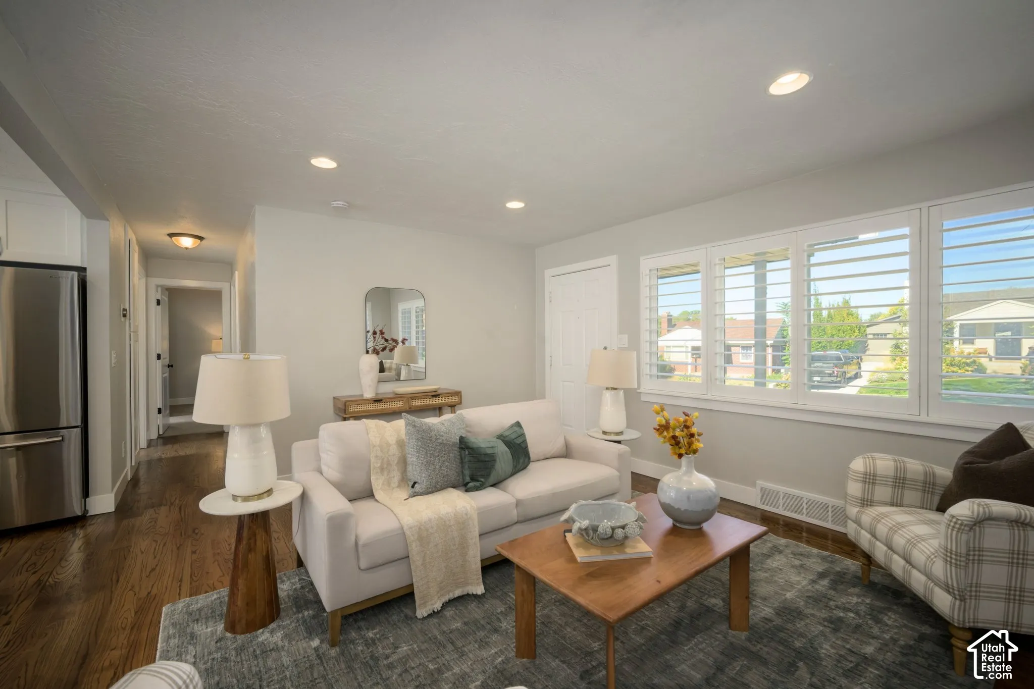 Recessed lighting illuminates the living area with hardwood flooring