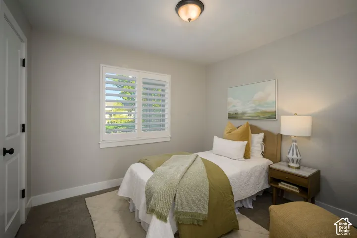 Recessed window with white plantation shutters, carpeted flooring, and a flush-mount ceiling light
