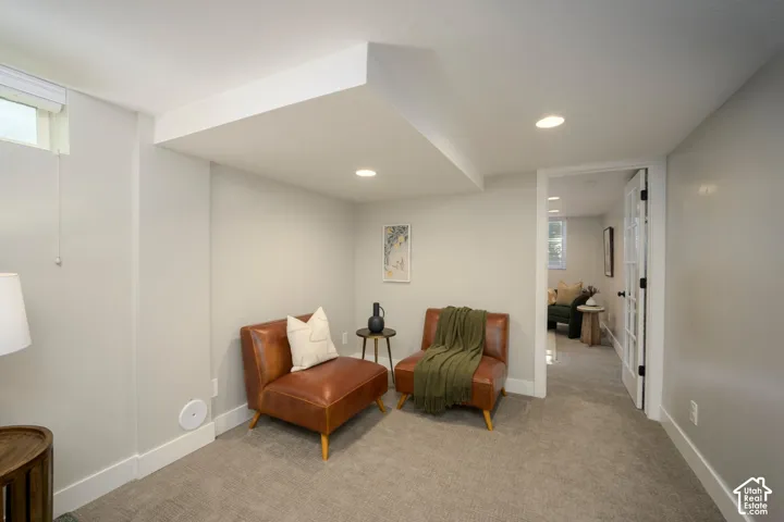 Recessed lighting, light gray wall tones, and carpeted flooring