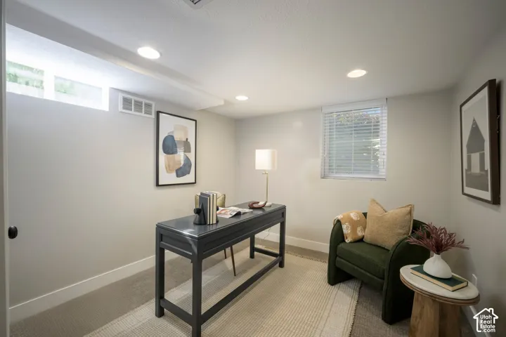 Recessed lighting, wall-to-wall carpeting, and neutral wall tones