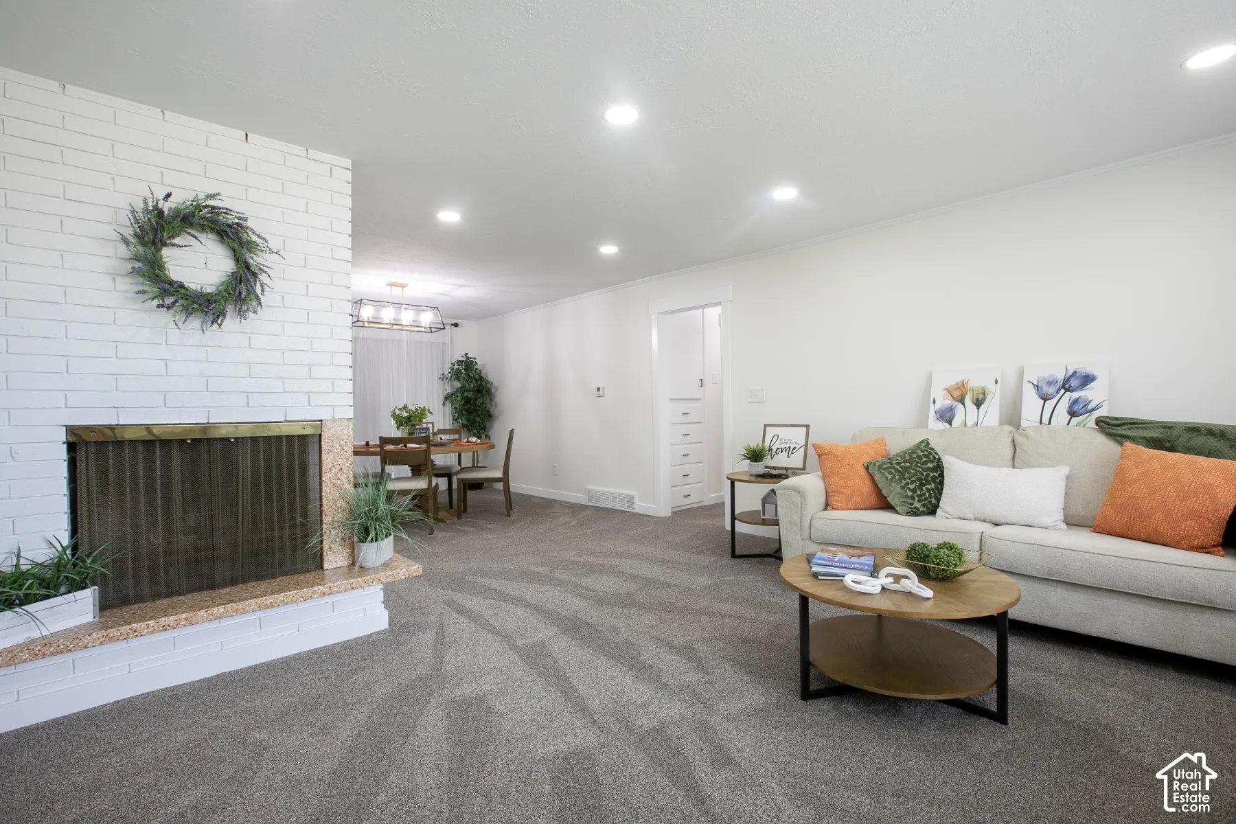 White brick fireplace with a granite hearth and brass-toned screen