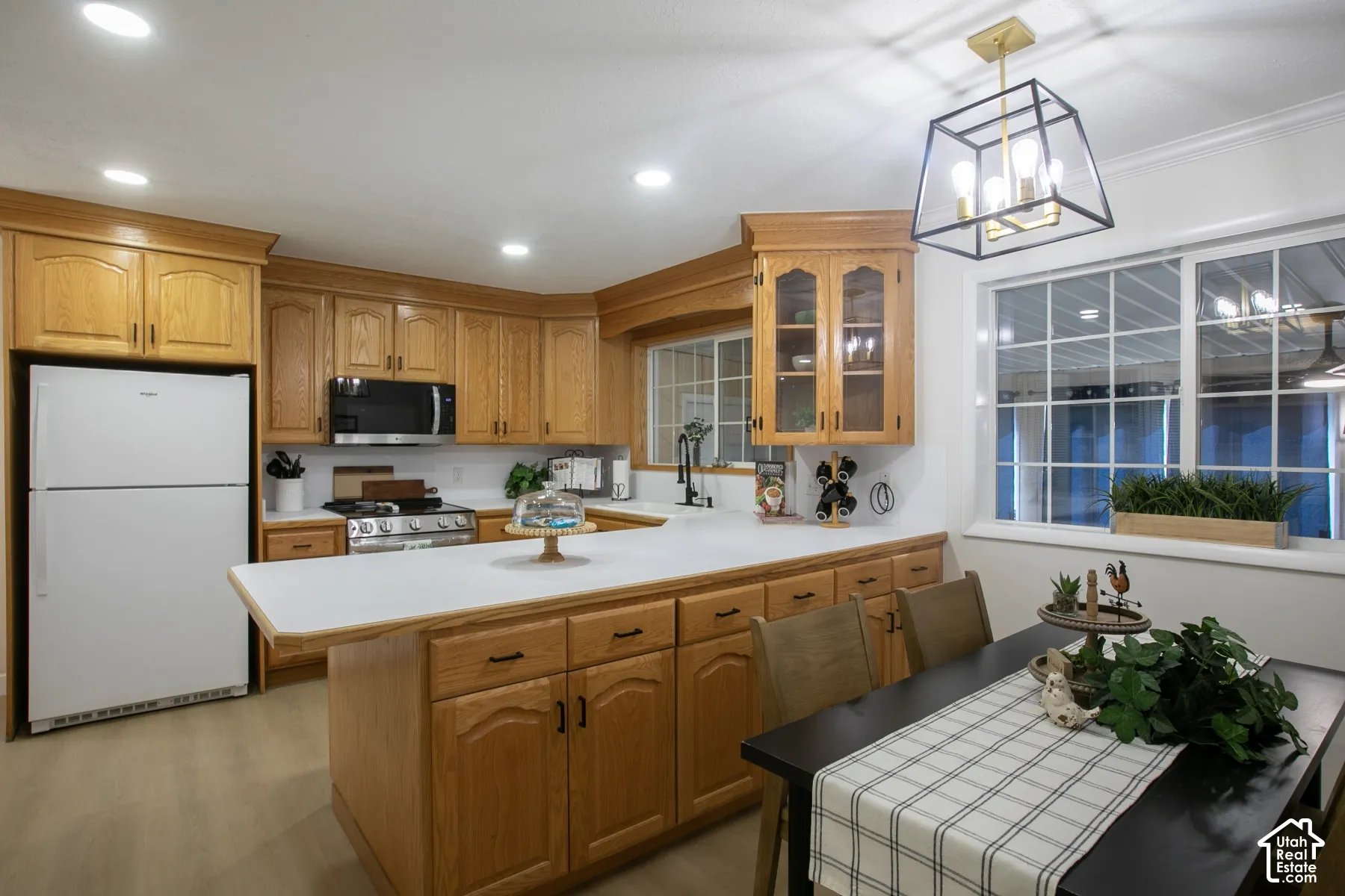 Kitchen featuring wood-finish cabinetry, white countertops, and stainless steel appliances