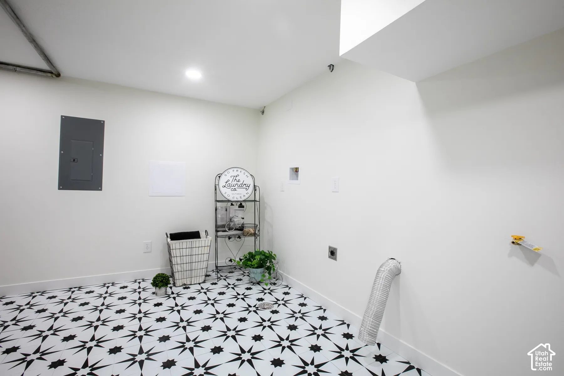 Laundry area featuring a black and white patterned tile floor and recessed ceiling lighting