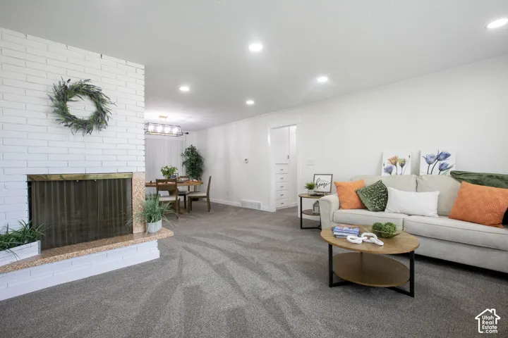 White brick fireplace with a granite hearth and brass-toned screen