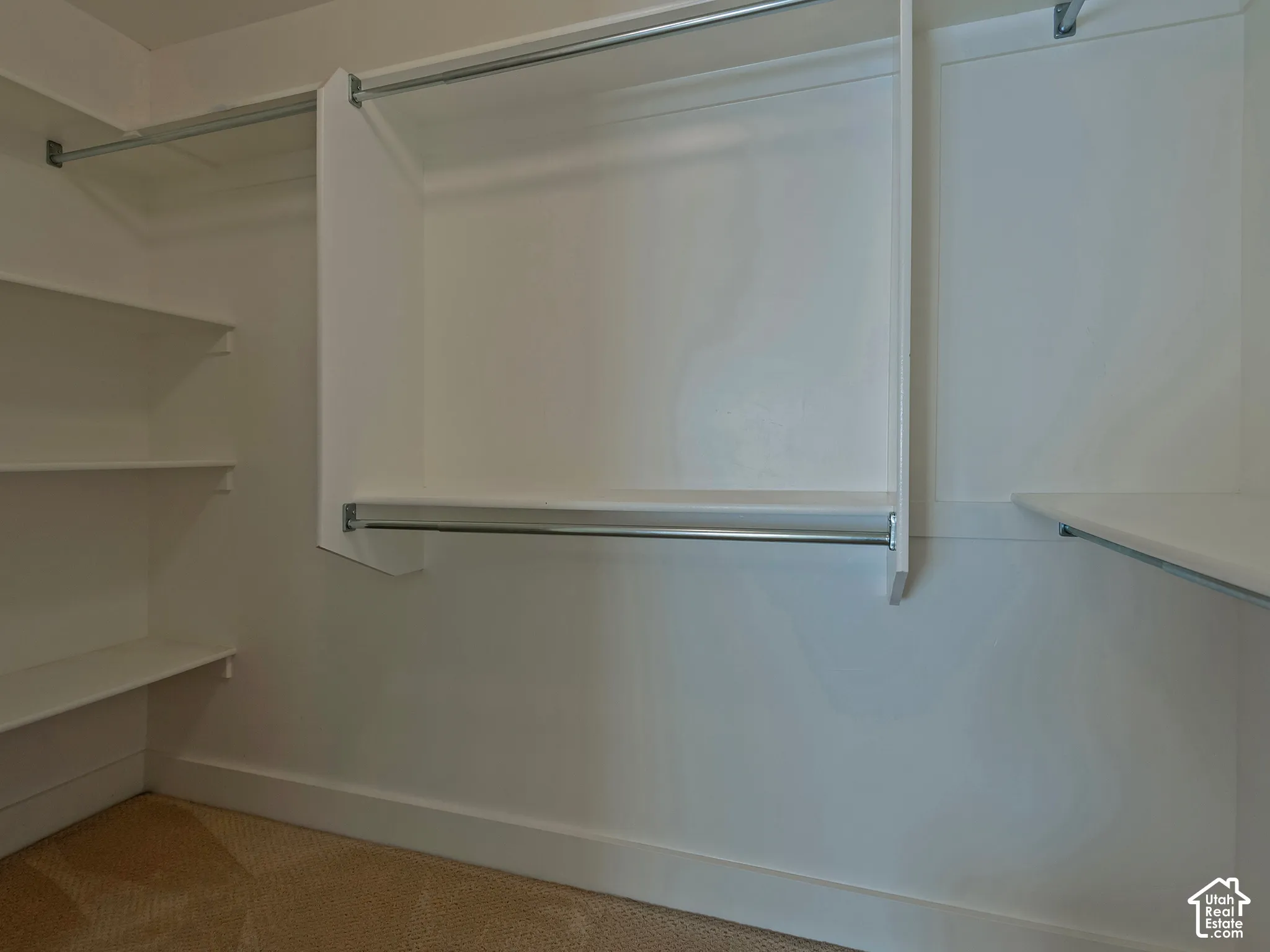 Built-in closet organization with multiple hanging rods and shelving units