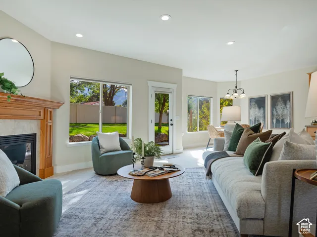Recessed lighting illuminates an interior with light-toned walls and wood-finish flooring