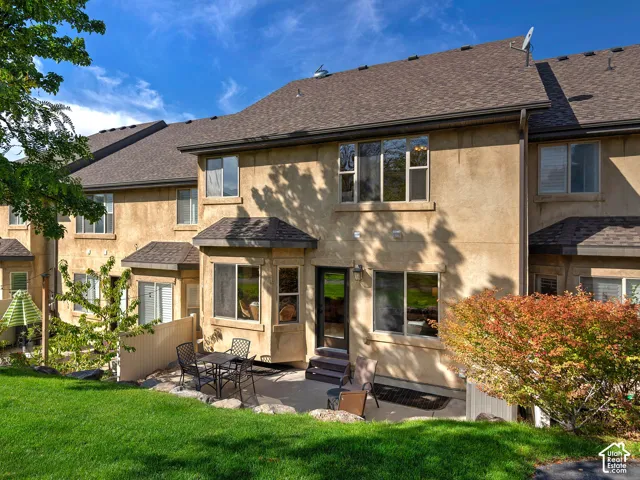 Backyard Stucco exterior with multiple windows, leading to a private patio, and a grass lawn