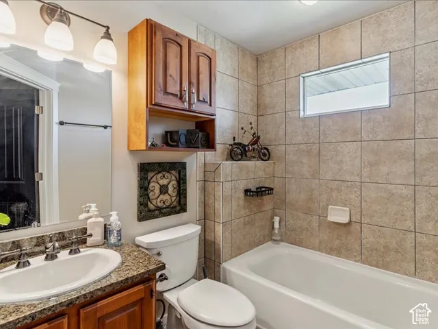 Wood-finish vanity with an integrated sink and a speckled countertop