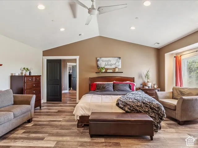 Vaulted ceiling with recessed lighting and a ceiling fan, wood-finish flooring, and a window with blinds