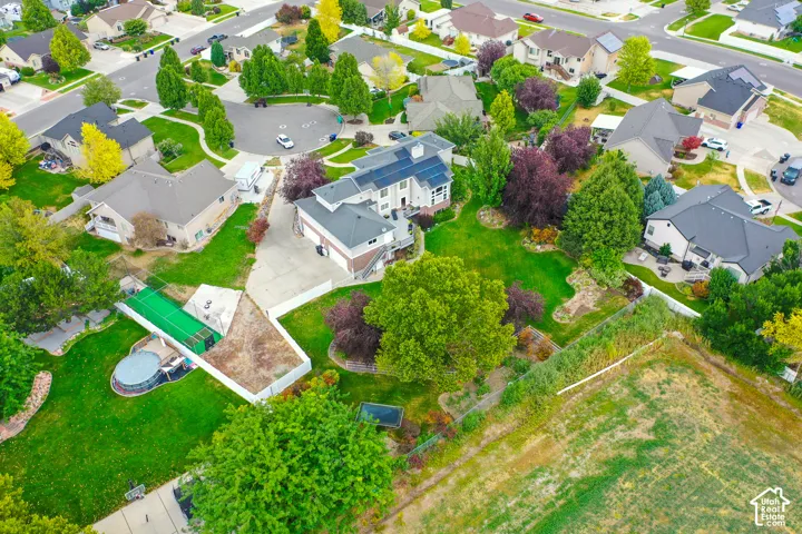 Spacious property featuring a large lawn, mature trees, and an established neighborhood setting