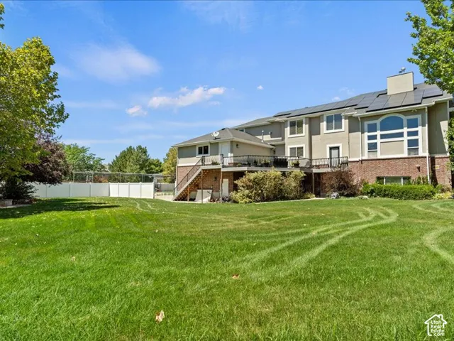 Expansive manicured lawn with a privacy fence