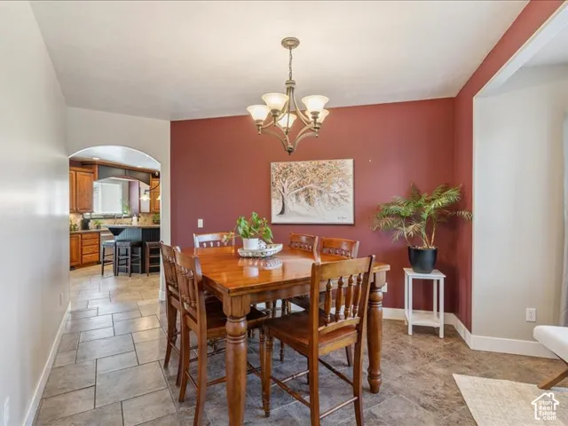 Recessed lighting, arched entryway, and tile flooring