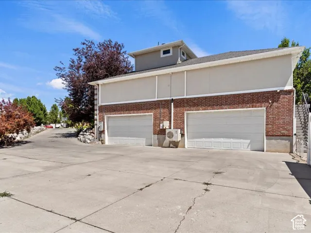 Brick and stucco exterior with two garage doors
