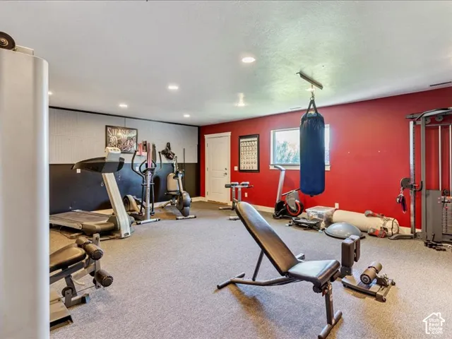 Finished interior space with wall-to-wall carpeting, recessed lighting, and a white interior door
