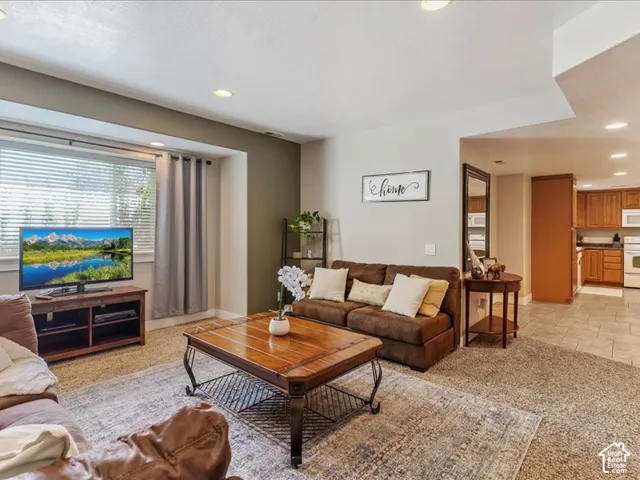 Recessed lighting, window with blinds, and carpeting