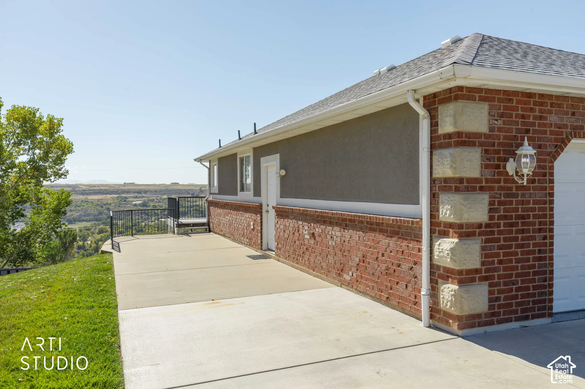 Concrete patio featuring an iron railing