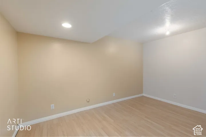 Recessed ceiling lighting, smooth ceiling finish, wood-finish flooring, two-tone wall paint