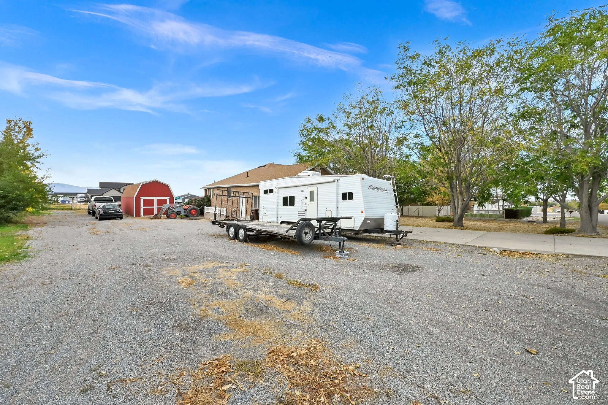 Gravel Driveway with RV/Car Parking and Storage Barn.